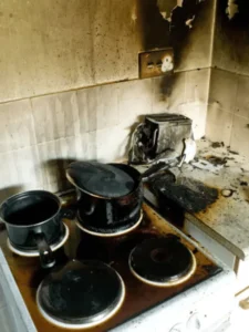 Emergency Fire Damage Restoration burnt pots on top of a stove top